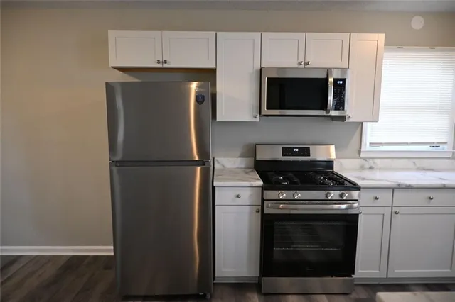 a kitchen with a stove and a microwave