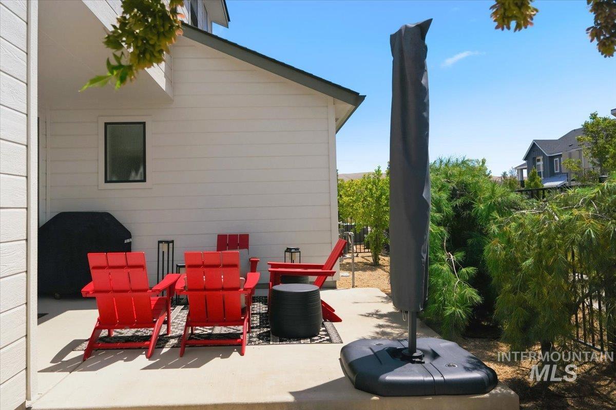 3794 South Single Tree Avenue Boise, ID 83716 - Photo 41 of 50 Outdoor patio featuring a concrete slab, white horizontal siding, and a black metal fence