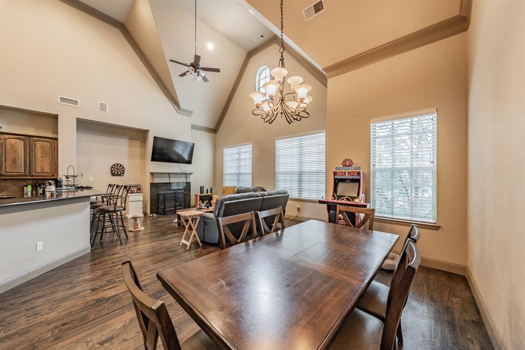 575 Rockingham Drive Irving, TX 75063 - Photo 16 of 38 a dining room with furniture a chandelier and wooden floor