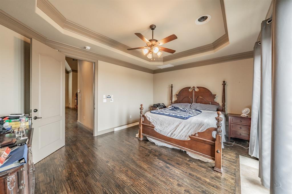 575 Rockingham Drive Irving, TX 75063 - Photo 18 of 38 a bedroom with a bed and a chandelier