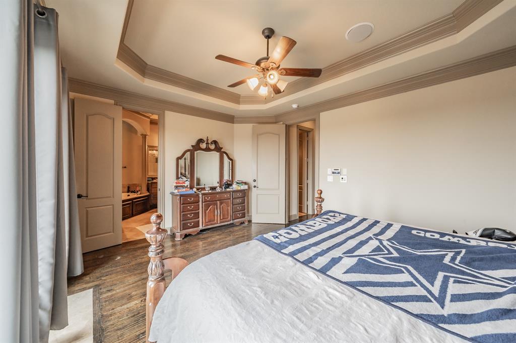 575 Rockingham Drive Irving, TX 75063 - Photo 19 of 38 a bedroom with a bed and a chandelier