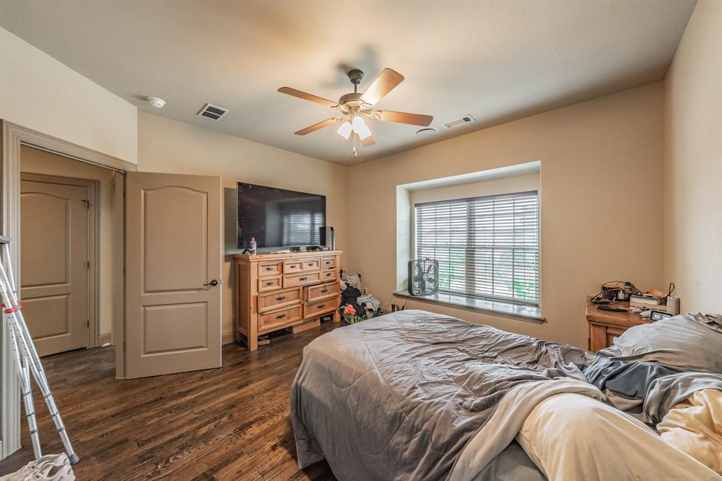 575 Rockingham Drive Irving, TX 75063 - Photo 26 of 38 a bedroom with a bed and a flat screen tv