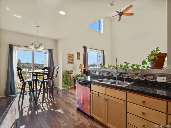 a kitchen with counter space dining table and chairs