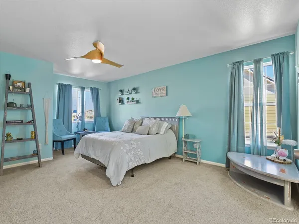 a spacious bedroom with a bed and a window