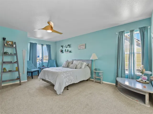 a spacious bedroom with a bed and a window