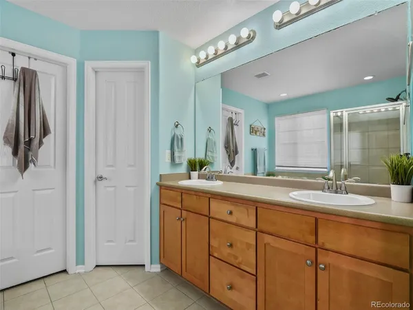 a bathroom with a double vanity sink and mirror