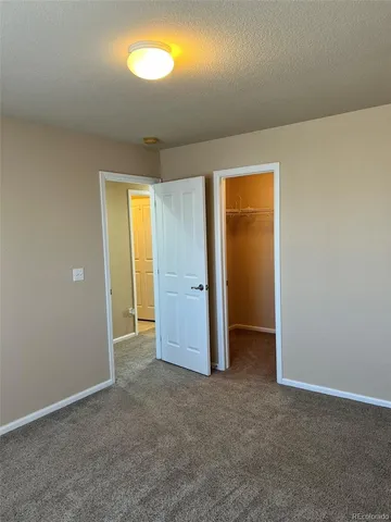 an empty room with windows and closet