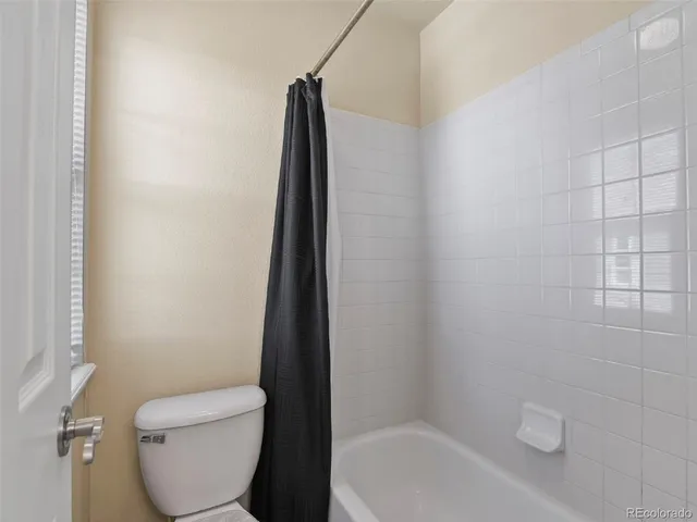 a bathroom with a toilet and a bathtub