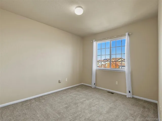 an empty room with cabinet and window