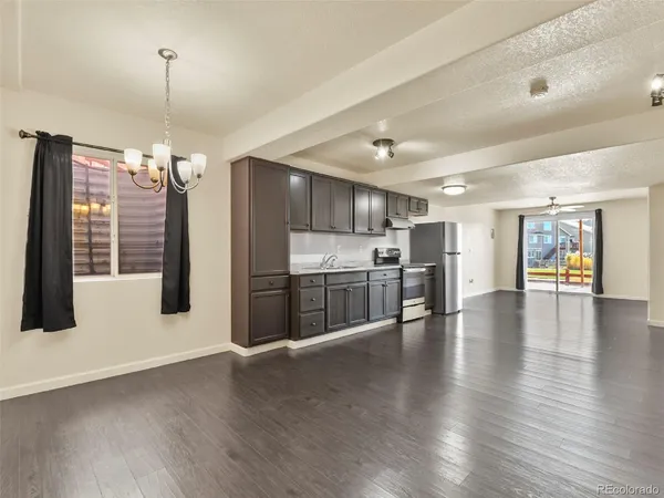 a view of a kitchen with a stove and wooden floor