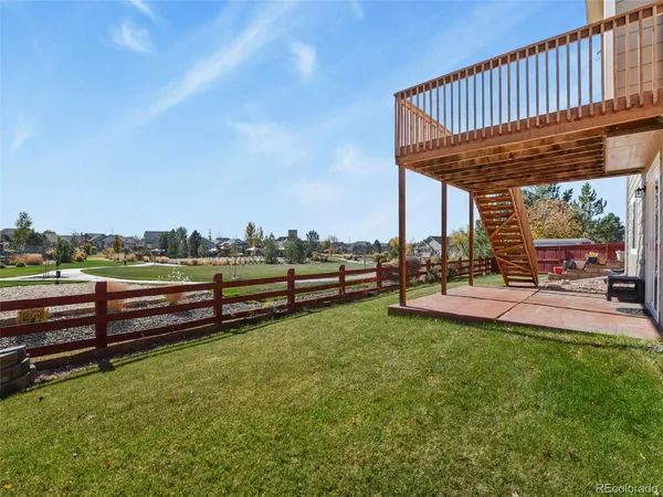 a view of a roof deck with couches and table and chairs and potted plants