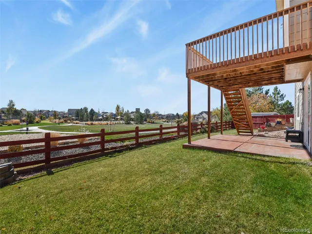 a view of a roof deck with couches and table and chairs and potted plants