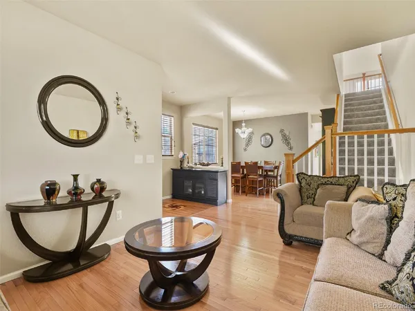 a living room with furniture a rug a window and a fireplace