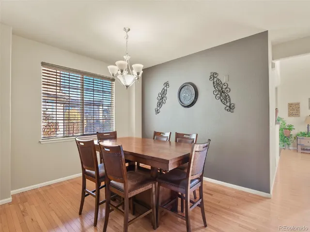 a view of a dining room with furniture wooden floor and a chandelier