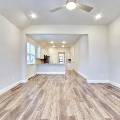a view of a kitchen with a sink and a refrigerator