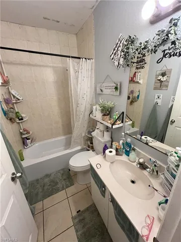 a bathroom with a sink vanity mirror and toilet