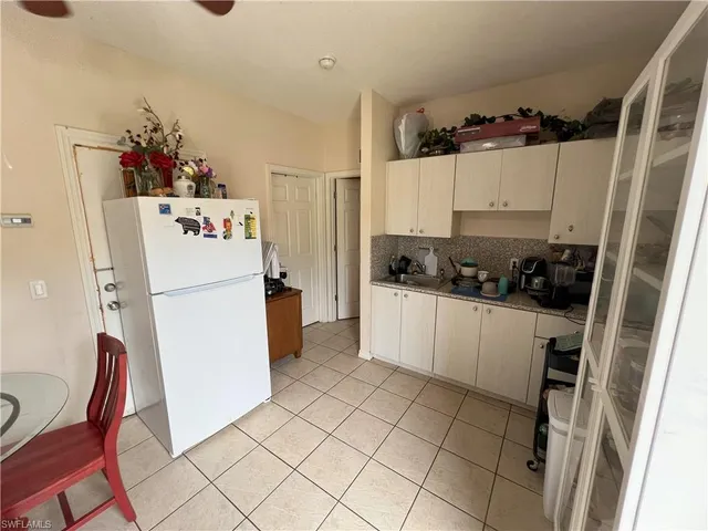 a kitchen with refrigerator and cabinets