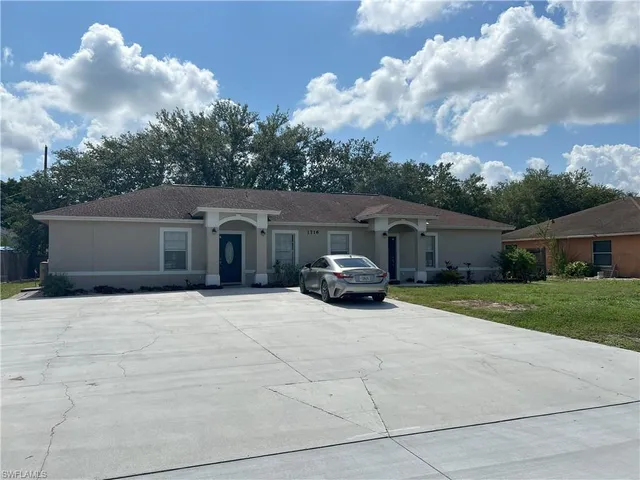 a house view with a sitting space and garden