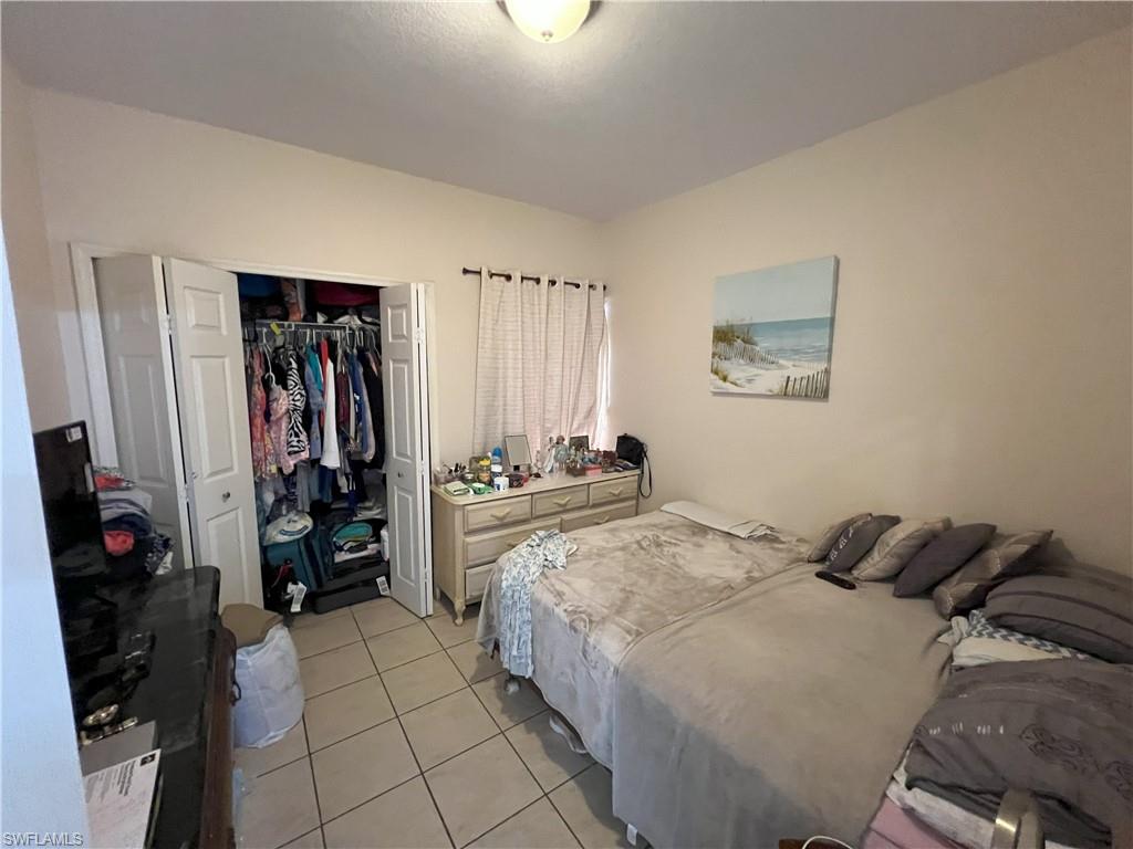 1716 48th Street Southwest Naples, FL 34116 - Photo 19 of 23 a bedroom with a bed and a walk in closet