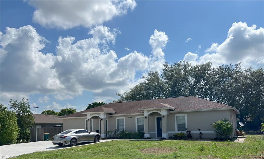 1716 48th Street Southwest Naples, FL 34116 - Photo 2 of 23 a aerial view of a house with swimming pool and green space