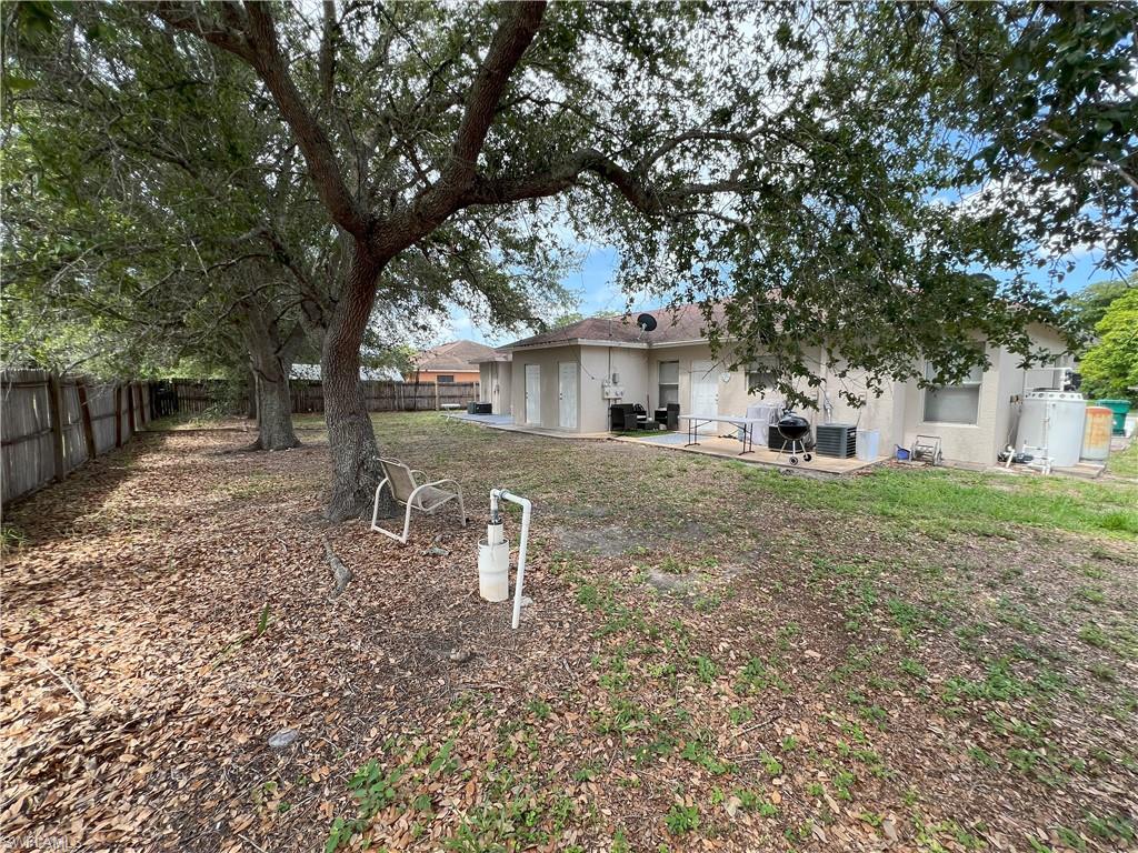 1716 48th Street Southwest Naples, FL 34116 - Photo 23 of 23 a front view of a house with a yard