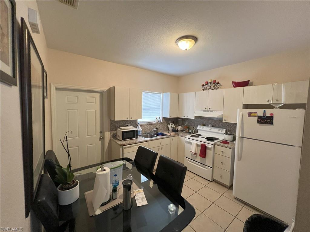 1716 48th Street Southwest Naples, FL 34116 - Photo 5 of 23 a view of a kitchen with sink and refrigerator