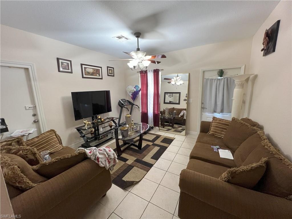 1716 48th Street Southwest Naples, FL 34116 - Photo 10 of 23 a living room with furniture and a flat screen tv