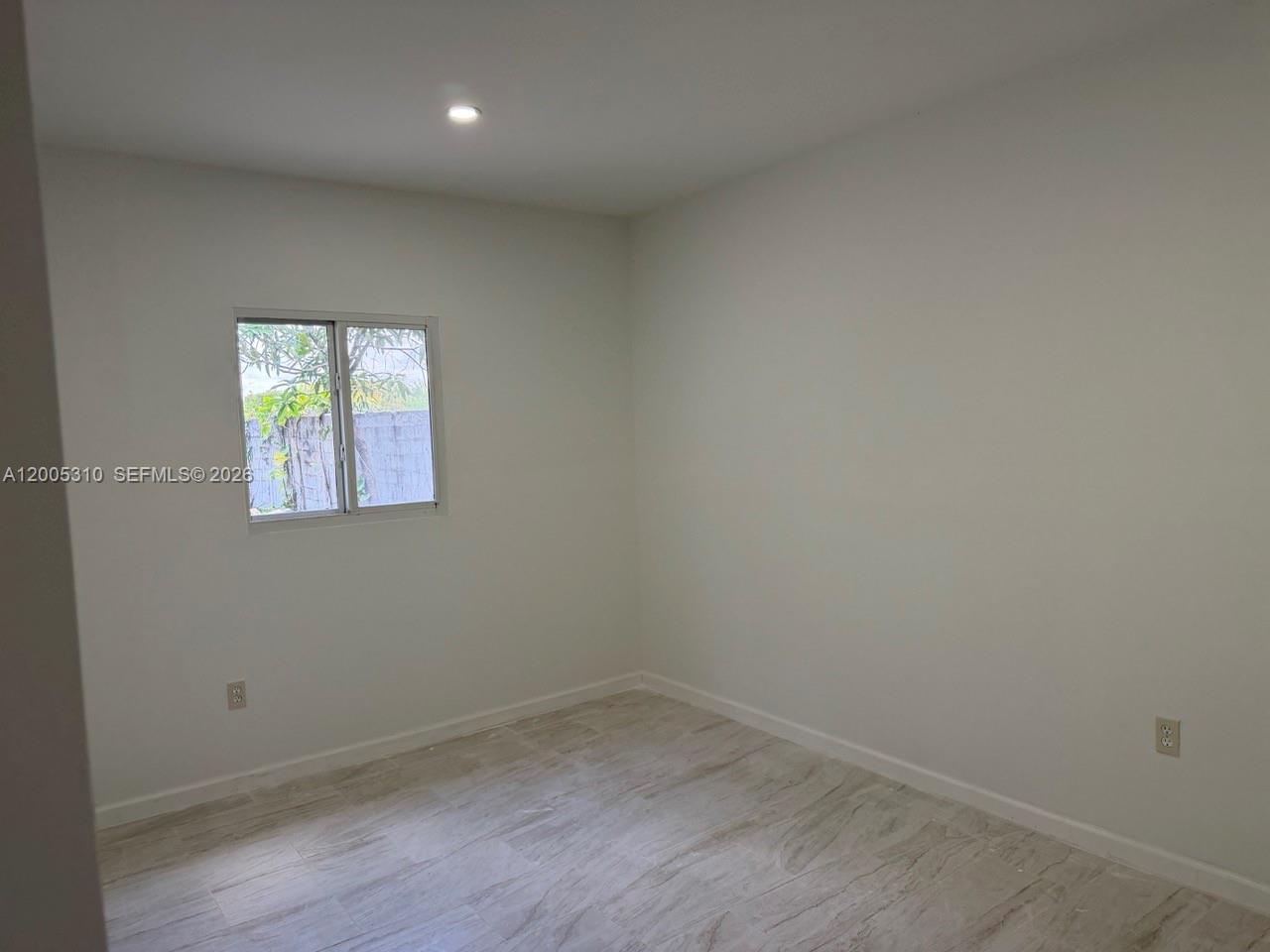2335 Northwest 68th Street Miami, FL 33147 - Photo 15 of 19 an empty room with a window