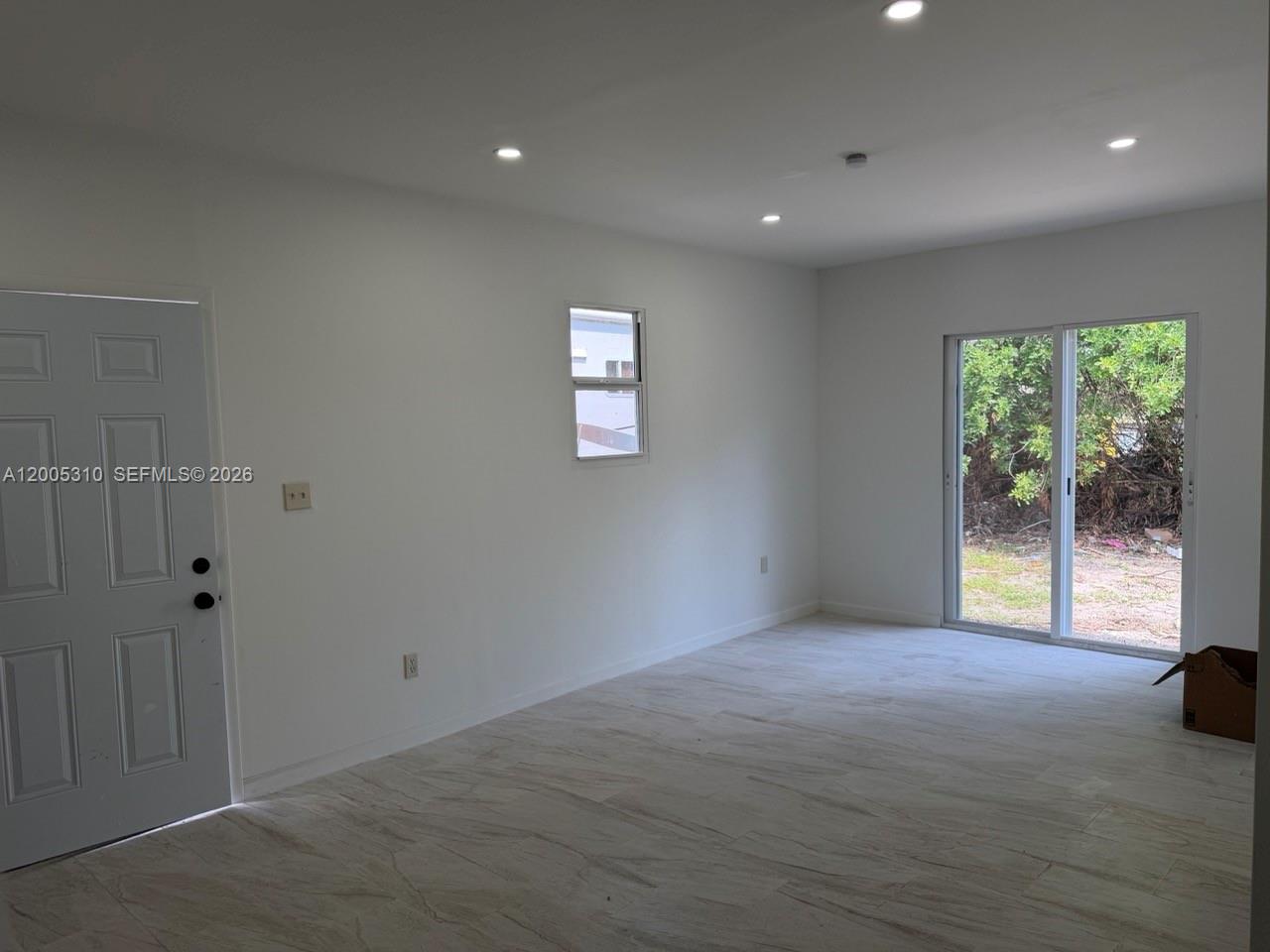 2335 Northwest 68th Street Miami, FL 33147 - Photo 5 of 19 an empty room with windows