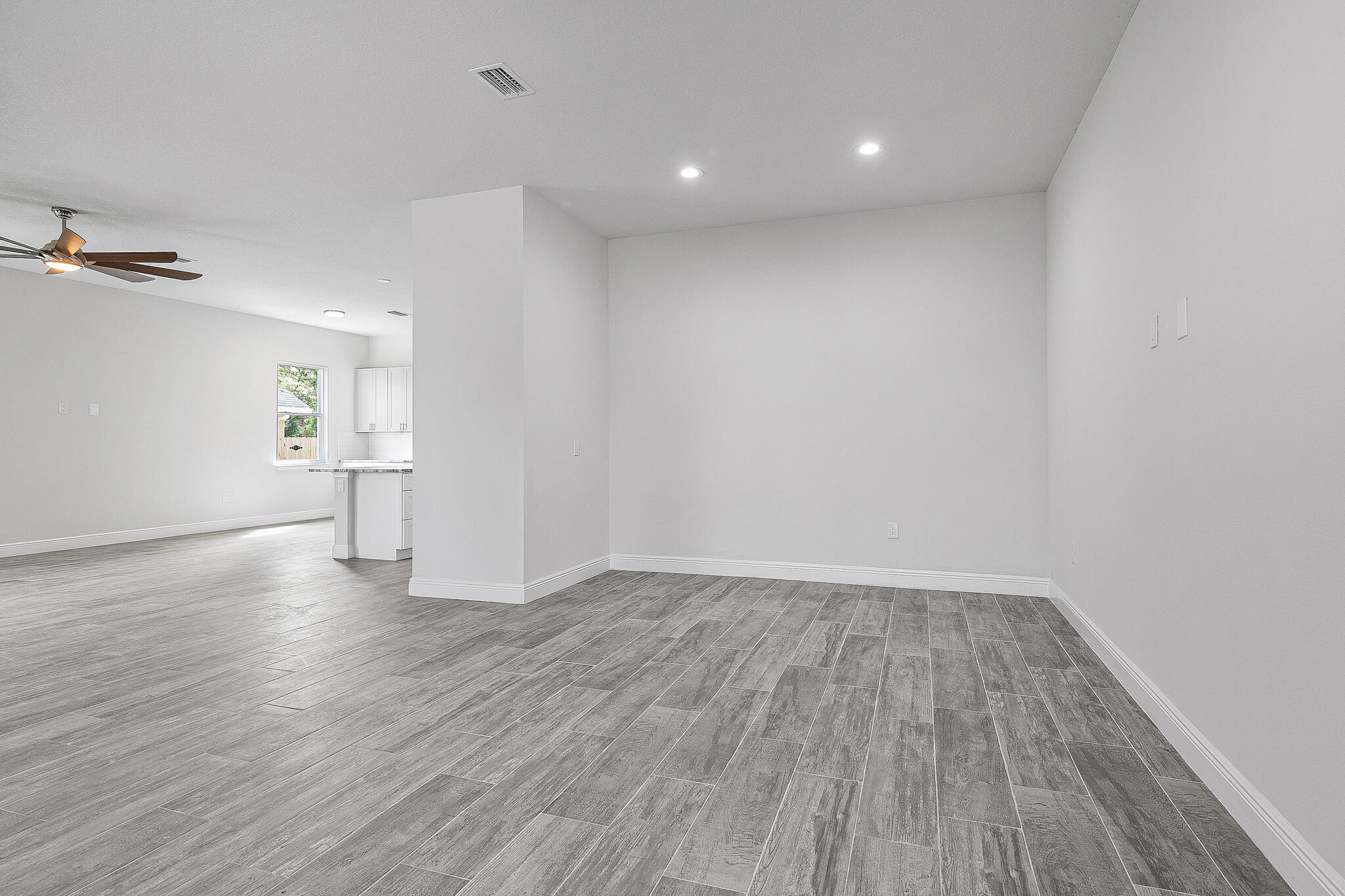 3240 Aspen Road Southeast Palm Bay, FL 32909 - Photo 7 of 12 wooden floor in an empty room with a window