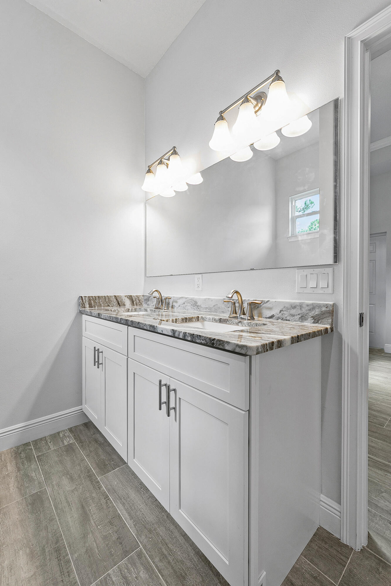 3240 Aspen Road Southeast Palm Bay, FL 32909 - Photo 10 of 12 a bathroom with a sink and chandelier