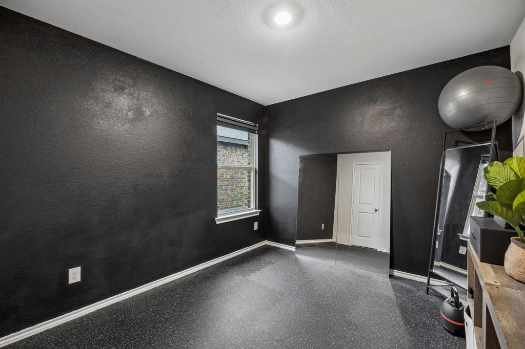 1107 Ringgold Road Forney, TX 75126 - Photo 23 of 27 Secondary bedroom #3 currently used as workout room with textured black walls, recessed ceiling lighting, a window with blinds, white baseboards, and dark flooring