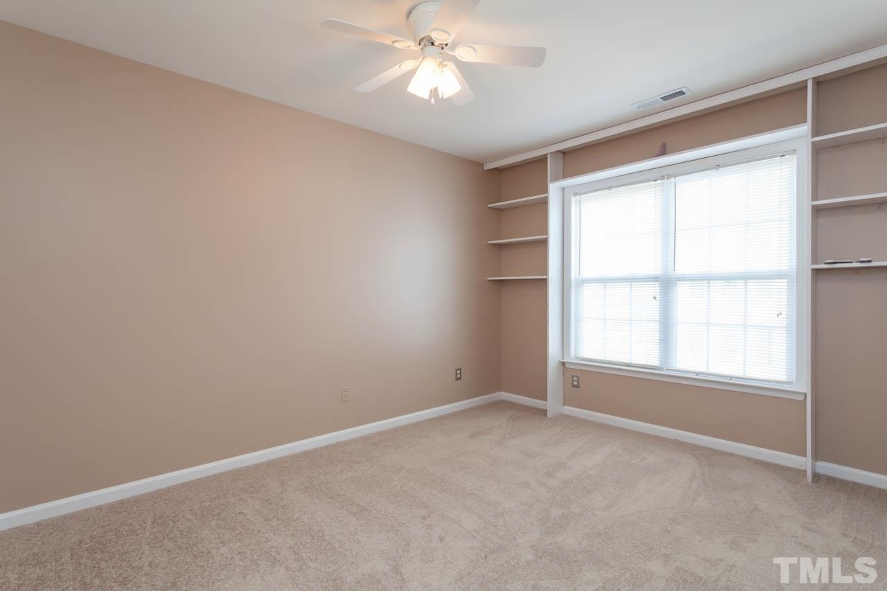 5541 Red Robin Road Raleigh, NC 27613 - Photo 15 of 23 an empty room with a window and a ceiling fan