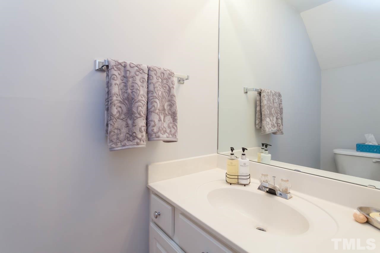 5541 Red Robin Road Raleigh, NC 27613 - Photo 17 of 23 a bathroom with a sink vanity and a mirror
