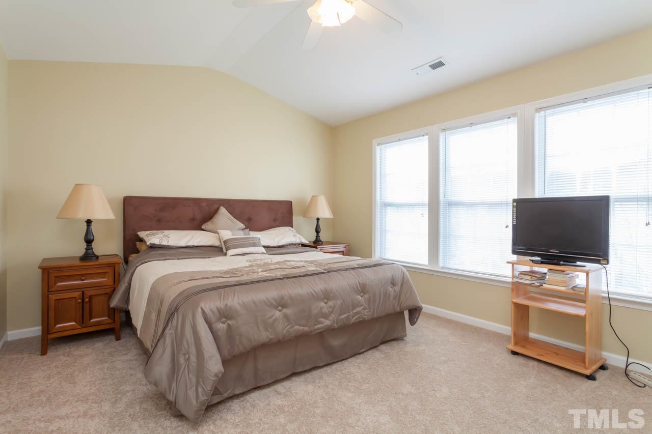 5541 Red Robin Road Raleigh, NC 27613 - Photo 8 of 23 a bedroom with a bed and a flat screen tv