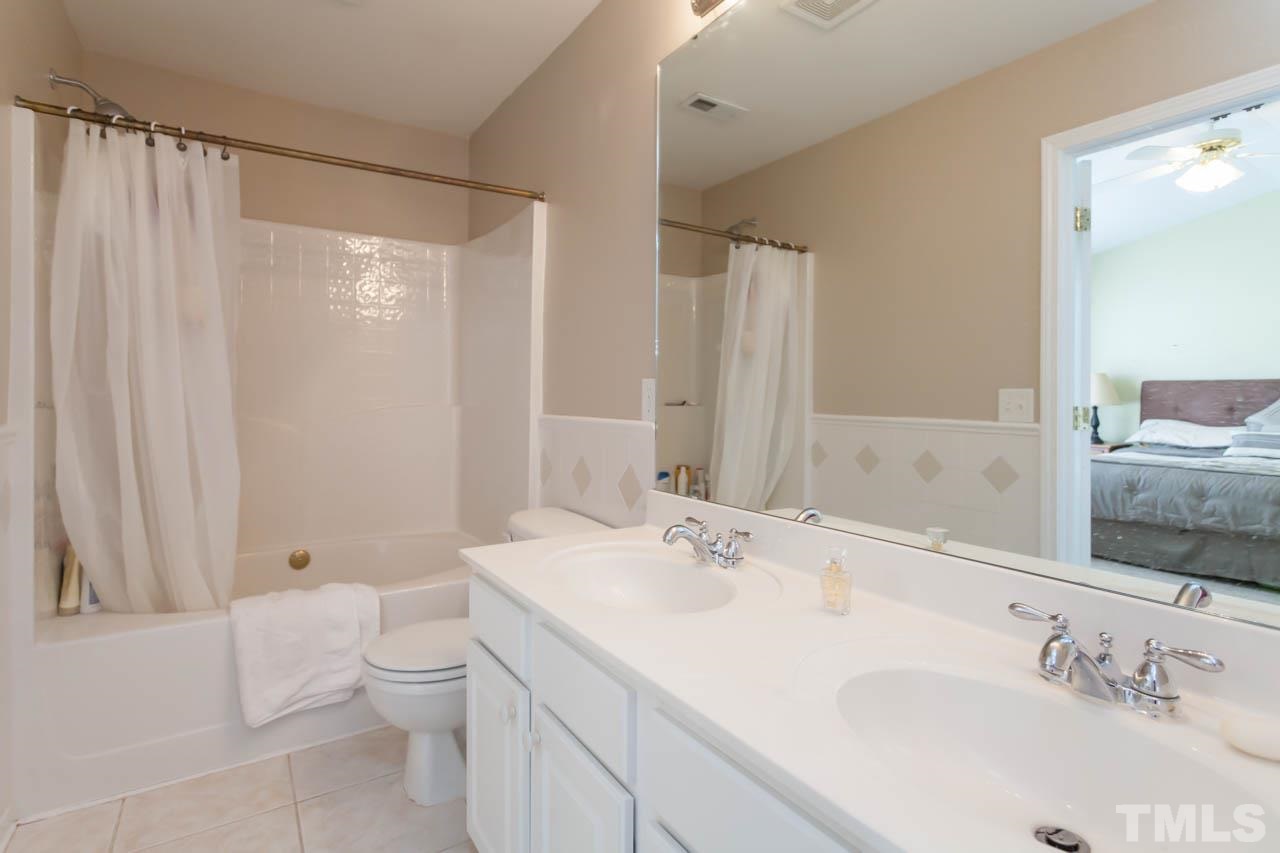 5541 Red Robin Road Raleigh, NC 27613 - Photo 9 of 23 a bathroom with a sink a toilet and shower