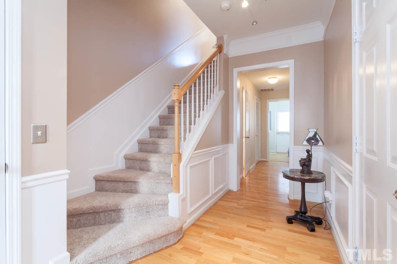 5541 Red Robin Road Raleigh, NC 27613 - Photo 10 of 23 a view of entryway with wooden floor and stairs