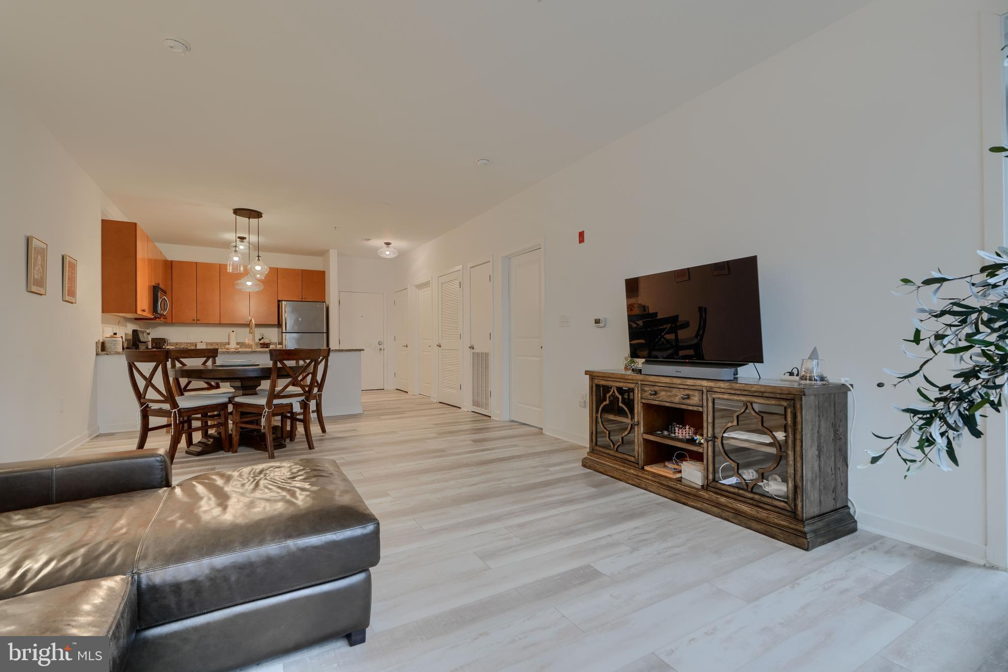 3201 St Paul Street, Unit 210 Baltimore, MD 21218 - Photo 17 of 38 a living room with furniture and a flat screen tv