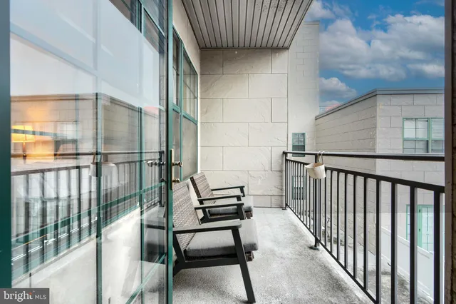 a view of a chairs and table in the balcony