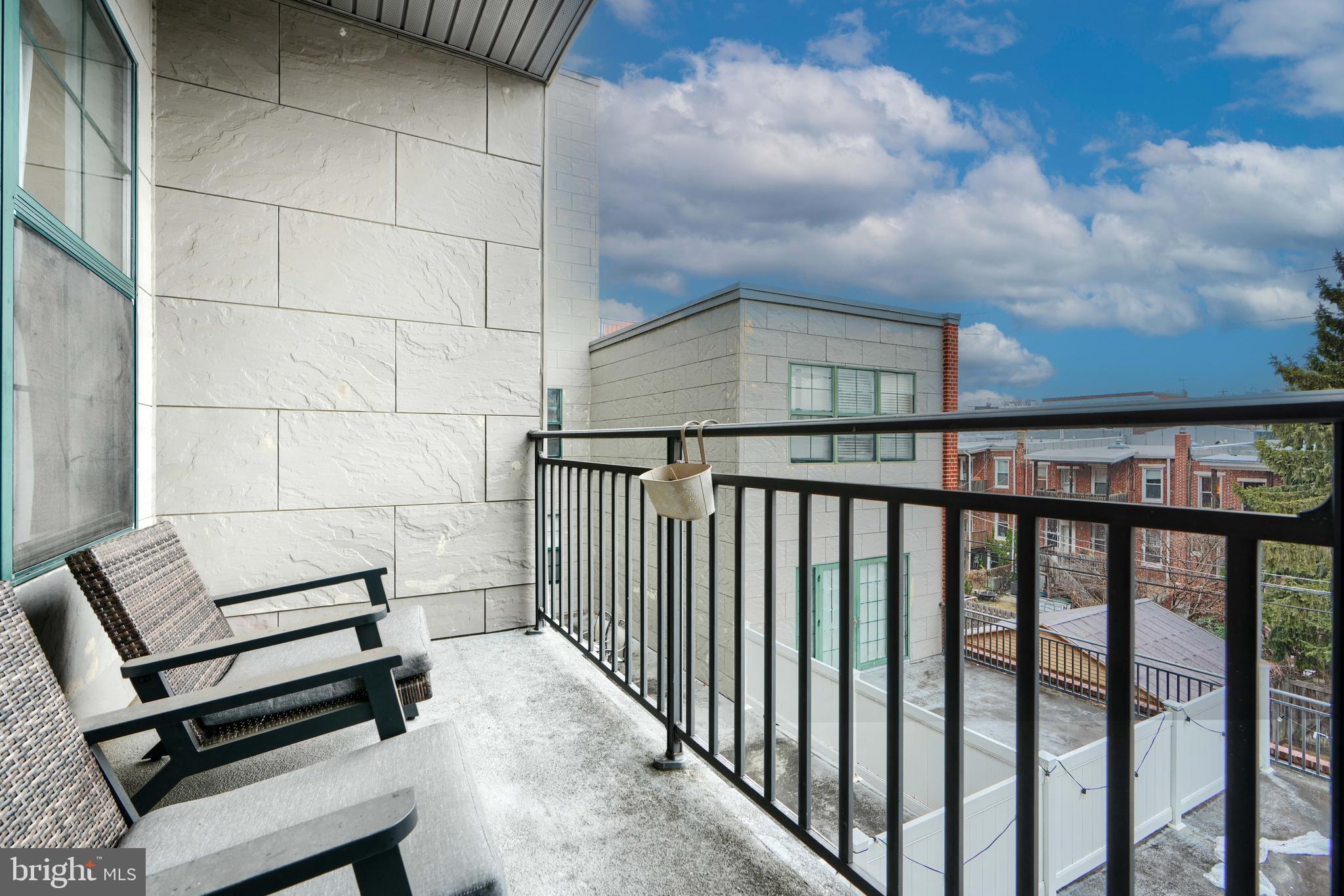 3201 St Paul Street, Unit 210 Baltimore, MD 21218 - Photo 20 of 38 a view of a chairs and table in the balcony