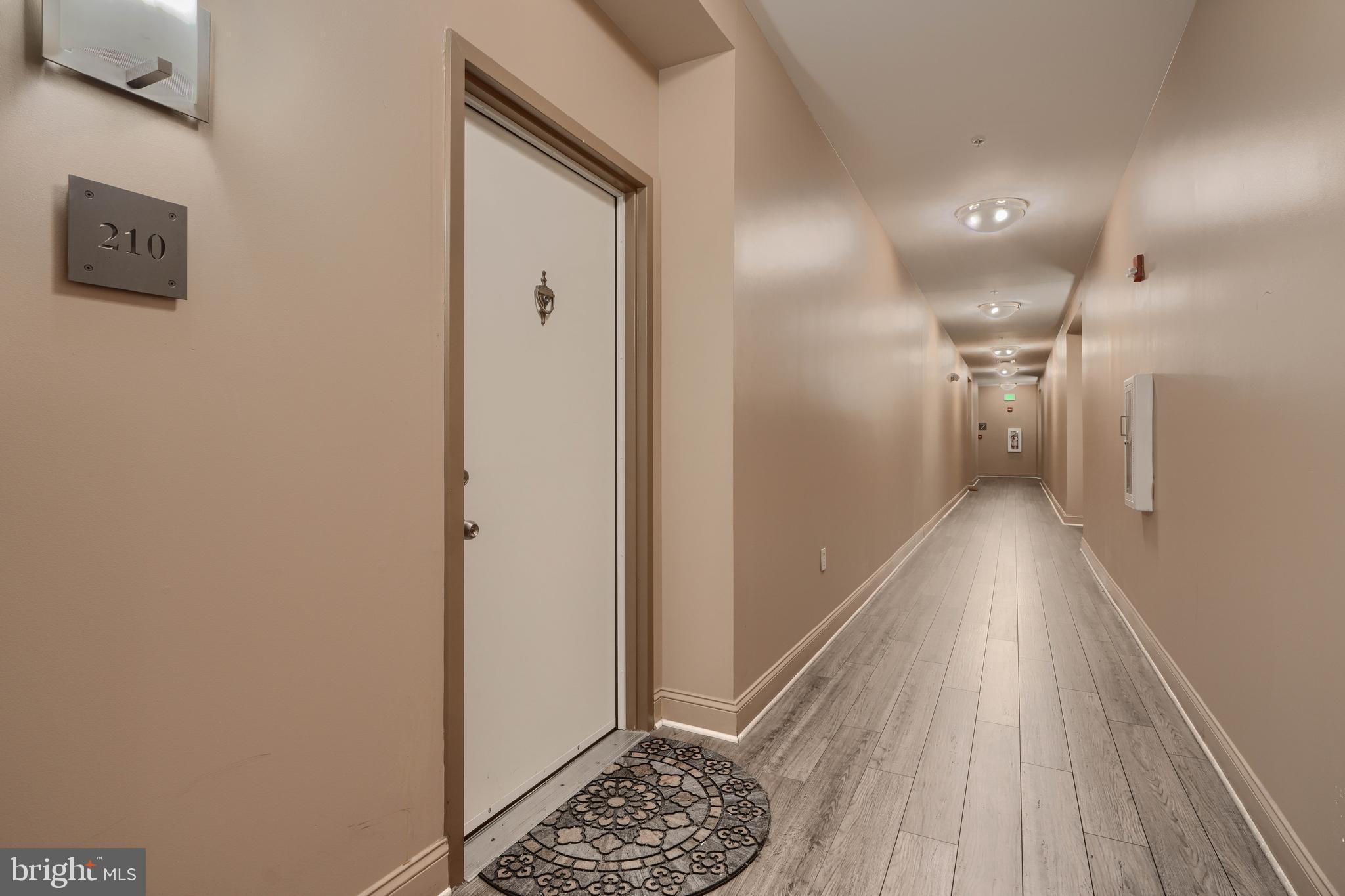 3201 St Paul Street, Unit 210 Baltimore, MD 21218 - Photo 38 of 38 a view of hallway with wooden floor