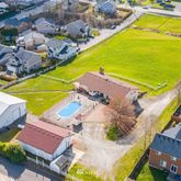 an aerial view of a house with a swimming pool