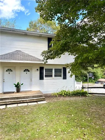 a front view of a house with a yard