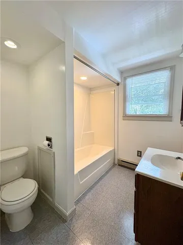a bathroom with a toilet a sink and a window