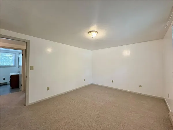 an empty room with a view of bathroom
