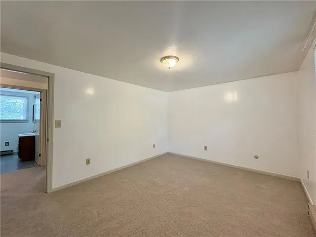 an empty room with a view of bathroom