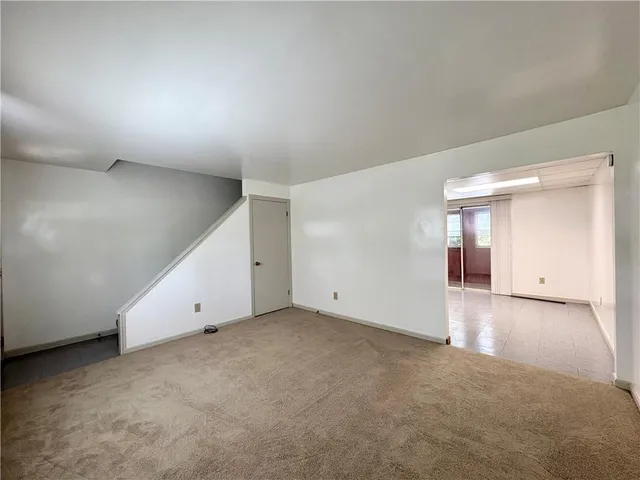 an empty room with closet and windows