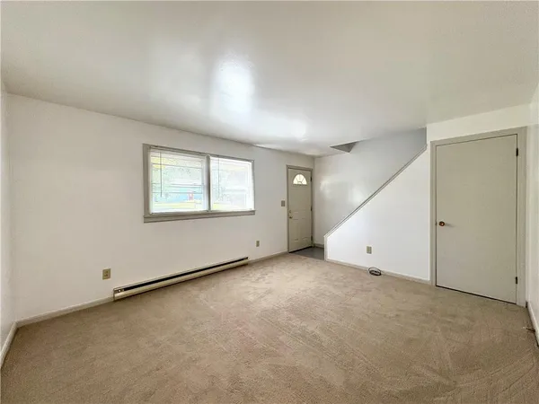 an empty room with a empty space and windows