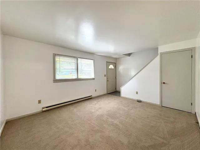 an empty room with a empty space and windows