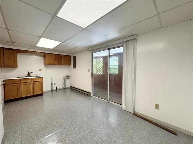 a view of a room with gym equipment and a view of living room